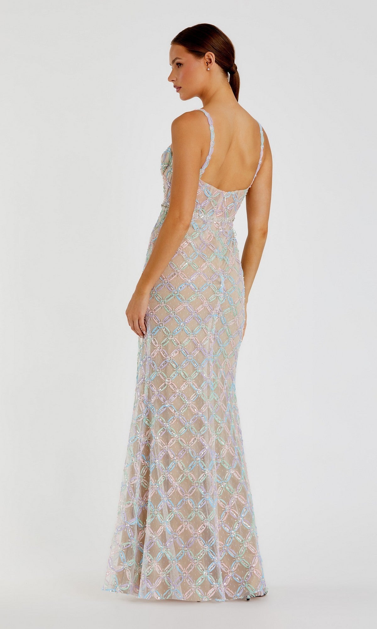 A woman wearing the Long Formal Dress: Mac Duggal 68886—a sleeveless, floor-length gown adorned with pastel sequins and featuring an open back—stands against a plain white background.